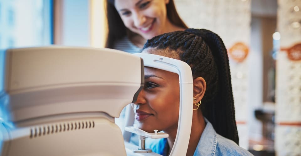 woman using vision tester at eye exam