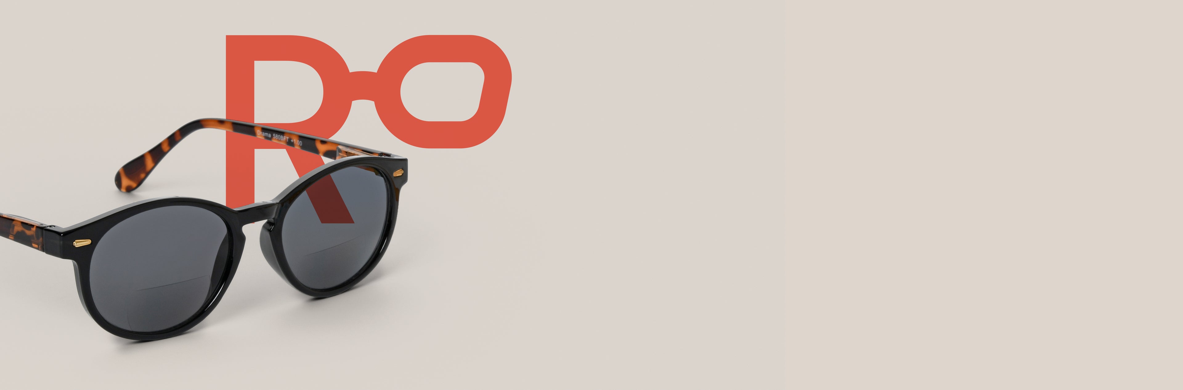 Sunglasses with tortoiseshell temples and black frame and dark lenses on a beige background with a red logo.